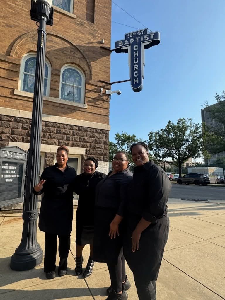 The waitstaff team outside a historic downtown venue